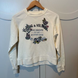 Zadig Voltaire sweatshirt  - Jättefin benvit Zadig Voltaire sweatshirt med blommor och fjärilar. Tröjan är använd 1-2 gånger och är i nyskick.