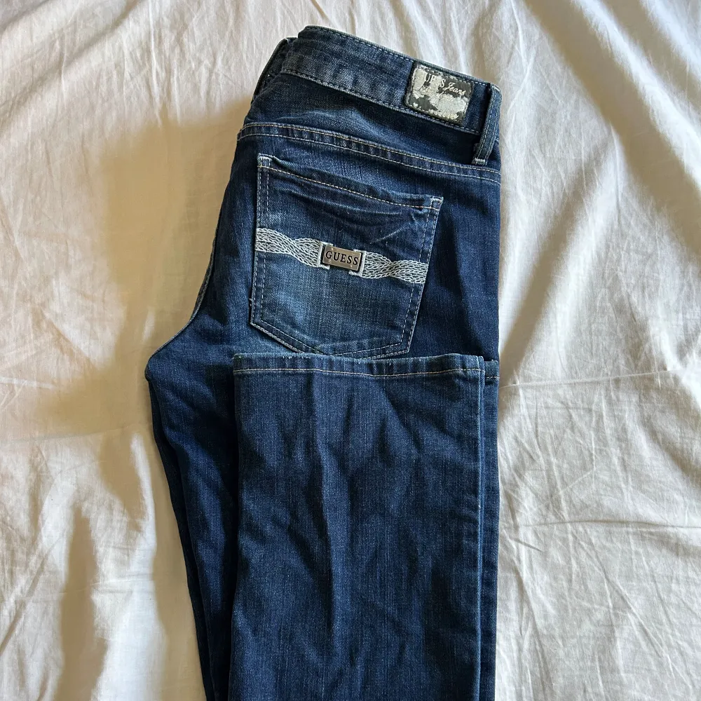Skit snygga lågmidjade mörkblåa Guess jeans som inte kommer till användning. Står w30, och satte väldigt bra på mig i storlek 38. Skit snygga detaljer på fickorna och framsidan. Innerbenslängden: ca 81-82cm Midjemått: 30w (enligt lappen). Jeans & Byxor.