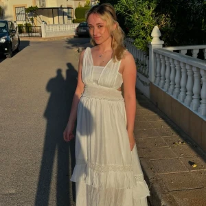 Long white dress - Have only used it once.  Fit type: regular Material: woven Stretch: non Shirred, Ruffle Lined, maxi, v-neck Waist line: mid-rise