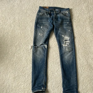 Dondup jeans blå - Köpta från nk, använda några gånger! väldigt bra skick med ett hål i byxan som design. Ny pris 2500 mitt pris 900   Byten kan göras!!! 