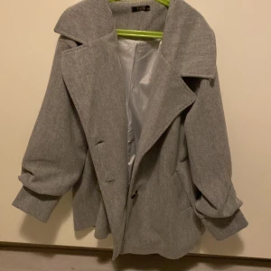 Grå medellång kappa Strlk S - Kappan e helt ny den är i storlek 36/s