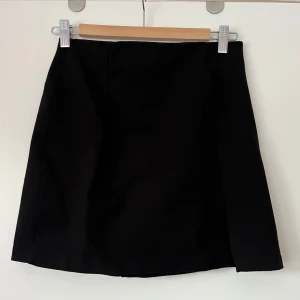 Svart kort kjol - Klassisk kort svart mini kjol som är åt de tajtare hållet. Storlek 38, skulle säga att de kan passa en större 36 också om man är mellan storlekar. Använd fåtal ggr. Bra skick. Frakt står köparen för. Org pris 199, säljer för 80kr