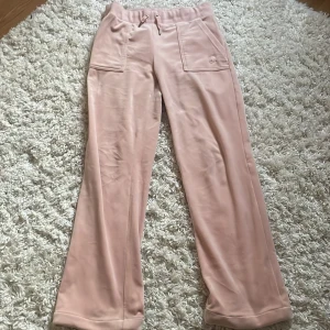 Uppsydda rosa juicy couture byxor - Dessa byxorna är i bra skick och inga defekter. Som jag skrev i titeln så är dessa uppsydda. Jag är 158 och dessa nuddar precis marken när jag står upp. 💕