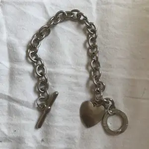 Silver armband med ett hjärta, enkelt att öppna och stänga. Aldrig använt, i perfekt skick!