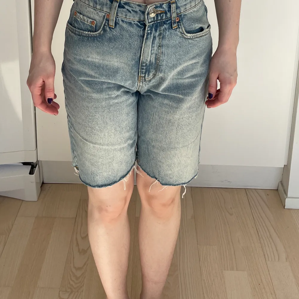 Ljusblå jeansshorts från Gina Tricot i stl 32. Endast använda en gång. Längd: 45 cm. Bredd i midjan: 37 cm.. Shorts.
