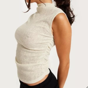 Ärmlös topp - Fin tröja från Nelly, aldrig använd. Nypris 249