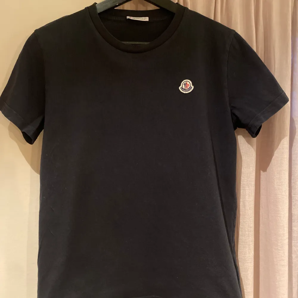 Säljer en svart Moncler T-shirt i storlek 14 år (164) Säljes i befintligt skick. Köpt på Nk i Göteborg. Nypris 1249kr Mitt pris 399kr. T-shirts.