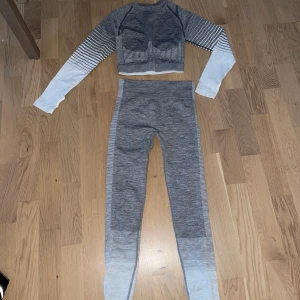 Träningskläder  - Grått / vitt sett med kort topp och tights strl S              Gråa shorts strl S                                                            Svarta 3kvarts byxor med grå kant strl S                        Alla plagg är oanvända. 100kr för alla 3 