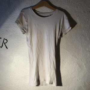Vit ribbad t-shirt - Vit ribbad t-shirt, i storlek xs. Finns likadan i svart (skicka om du vill ha bilder på den. Säljs tillsammans eller separat. Om du köper båda är priset 25kr:)