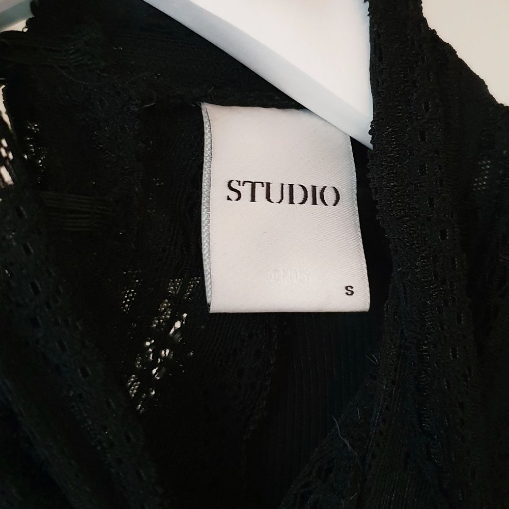 Färg: svart.  Strl: S.   Fin svart tröja av märket Studio. Använd vid ett tillfälle, mycket fint skick.  Detaljer av spetts uppe vid halsen, samt ärmslut. Slimmad modell.  Kommer ej till användning & stor garderobsrensning pågår! Frakt tillkommer, swish!. Toppar.