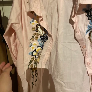 Skjorta baby pink  - Skjorta i baby pink färg och den har lite mönster blommor på är fin och i storlek S/Xs buda gärna priser