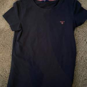 En marinblå T-shirt från Gant med litet tryck på bröstet med Gant. Använd väldigt få gånger och ser som ny ut. Storlek small. 