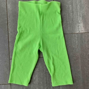  - Neongrönt set med crop top och cykelbyxor, båda i ribstickat material. båda använda 1 dag.  kan säljas tillsammans eller separat, frakti tillkommer