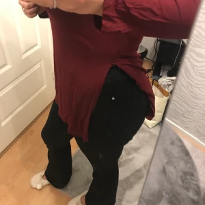 Nelly  - En långärmad tröja med slits. Super fin marin röd färg knap andvänt. Super fint med ett par utsvängda jeans. Den är storlek L men skulle nog säga att det är M eftersom den är så tajt 