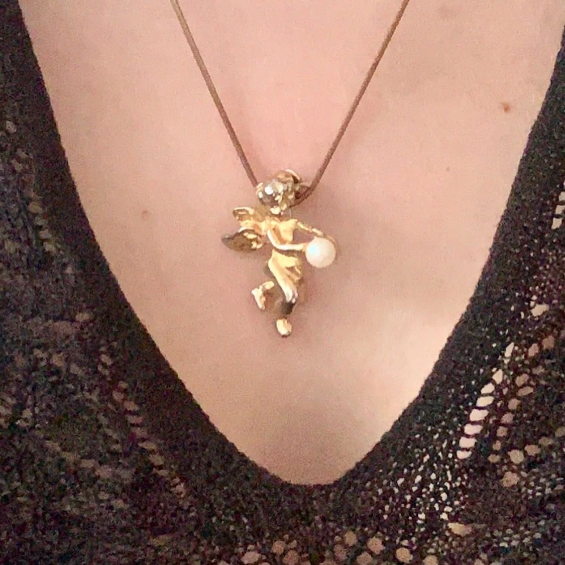 Halsband med ängel som håller pärla