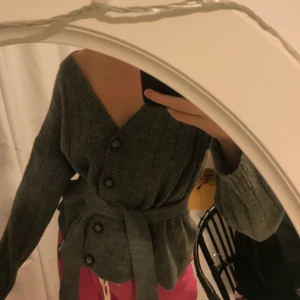 Kofta - Supersnygg grå stickad kofta köpt på Ginatricot! Nästan aldrig använd och i superfint skick!!! Går att använda utan bandet i midjan med!⭐️⭐️Storlek S, sitter perfekt på XS och M också🤩