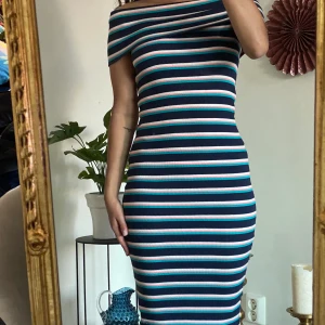 Lång randig off shoulder klänning - Jag säljer denna snygga blå, vit och rosa off shoulder klänning. Jag köpte den på ginatricot några år tillbaka men endast använt den några få antal gånger. Den är hyfsat lång på mig, går ner till mina ankles (är 155cm). Den är i storlek XS men stretchar så skulle kunna passa någon som bär S. Frakt tillkommer alternativt mötas upp vid TC/Hötorget ❣️