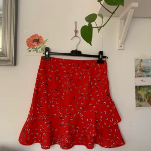 Kjol - Gullig rödblommig omlottkjol med volang. God kvalitet. Skriv för fler bilder. Möts upp i Falun eller skickar om du betalar frakten✌🏻