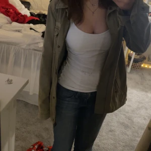 Olivgrön jacka med knappar - Säljer en Olivgrön jacka med knappar och fickor. Köpt secondhand och har ingen lapp men är i fint skick! 🎀