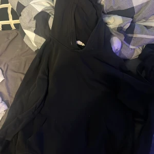 Svart hoodie från H&M - Säljer en klassisk svart hoodie från H&M. Perfekt för en avslappnad stil med en bekväm passform och huva. Passar bra till vardags och är lätt att matcha med andra plagg.