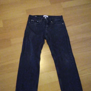Svarta jeans från Calvin Klein - Säljer ett par svarta jeans från Calvin Klein med en straight fit, har använts som baggy. Klassisk design med fem fickor och knappgylf. 