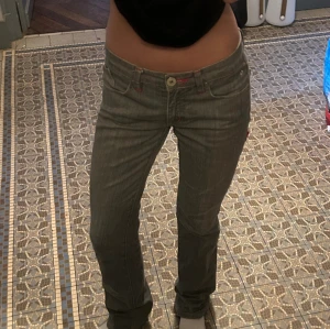 Lågmidjade bootcut jeans - Jag säljer nu mina så fina grå lågmidjade jeans! De är bootcut och i perfekt skick. De är storlek 34 och passar mig som är va 168 cm. Köpta i Paris.  De har lite färgade sömmar och en extra ficka bak. Kom privat för fler bilder eller vid frågor💘