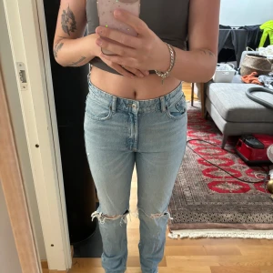 Zara jeans - Medel höga jeans från zara med två hål. Använd fåtal gånger bara så dem är k bra skick! Jag är 170cm lång och passar bra i längden på mig. 