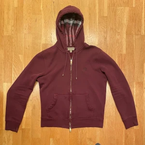 Vinröd hoodie från Burberry - Säljer en eftertraktad vinröd hoodie från Burberry. Den är i nyskick och utan skavanker. Vi frågor är det bara att höra av sig. Kan tänka mig att gå ner i pris vid snabb affär.