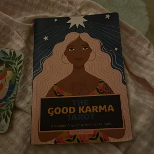 The Good Karma Tarot - Säljer 'The Good Karma Tarot', en nybörjarguide för att läsa tarotkort. Boken har en färgglad och inspirerande design med en illustration av en kvinna på omslaget. Perfekt för den som vill börja med tarotläsning. 