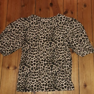 Leopardmönstrad tröja från lager 157s premium collection  - Säljer en leopardmönstrad tröja från Collection i storlek XS. Tröjan har ett djärvt mönster och är perfekt för att ge din outfit en trendig touch. Den har trekvartsärmar och en bekväm passform.