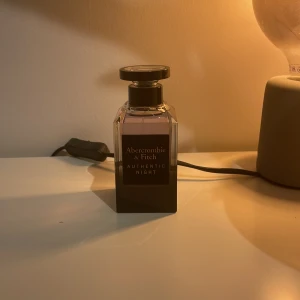 Authentic Night Eau de Toilette från Abercrombie & Fitch - Säljer en flaska Authentic Night Eau de Toilette från Abercrombie & Fitch. Flaskan har en elegant design med en mörk ton och svart lock. Perfekt för kvällar när du vill ha en sofistikerad doft. Har även magnetiskt lock. Missar original boxen därför säljer jag den billigt.