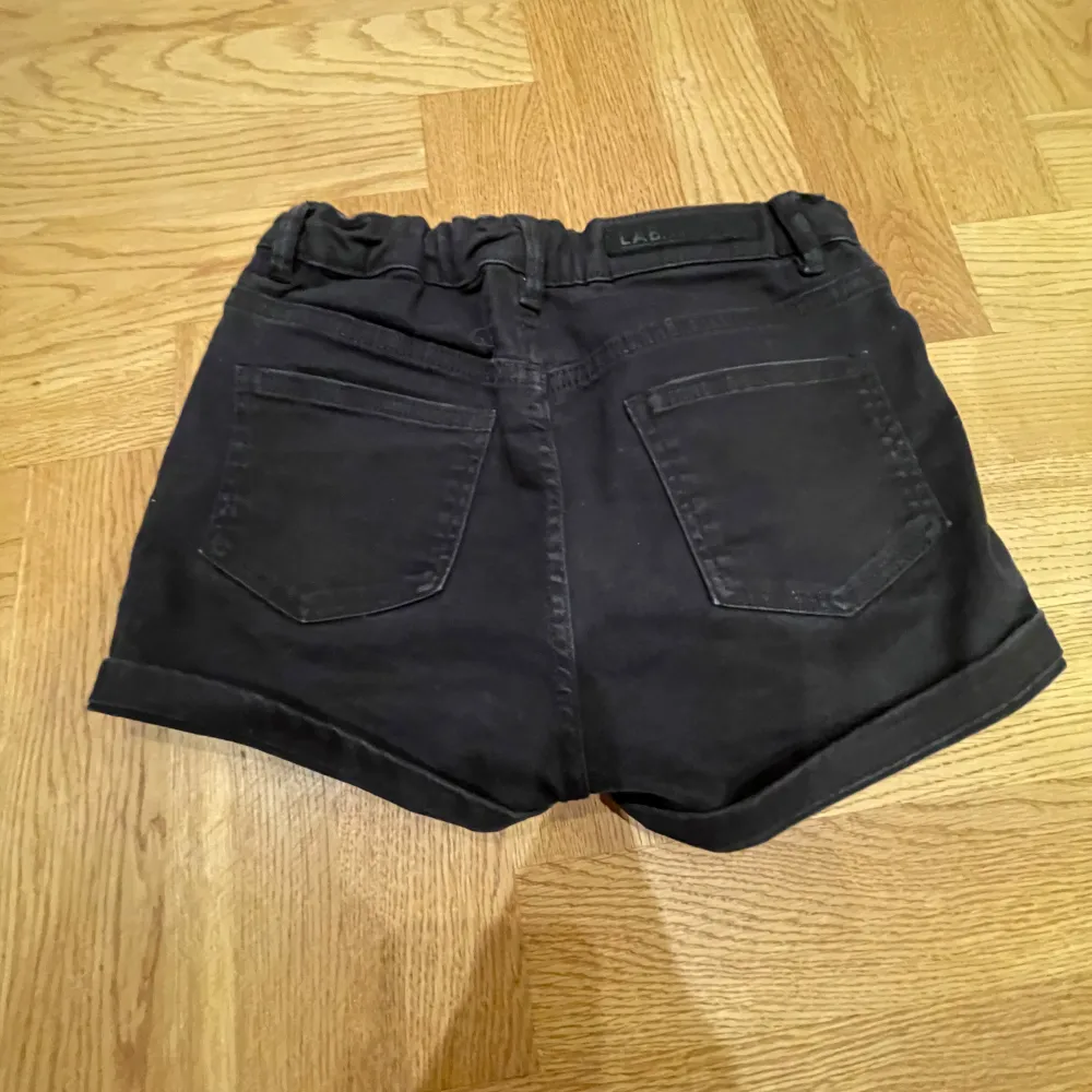 Säljer ett par svarta shorts i bra skick. De är medelmidjade med en knapp och dragkedja framtill. Shortsen har fickor både fram och bak.  Passar till det mesta och är riktigt bekväma!😇. Shorts.