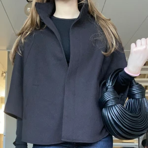 Poncho jacka - Superfin poncho/cape som är perfekt nu till hösten i okej skick en knapp saknas men det är inget men ser vid användning och materialet har någon skråva