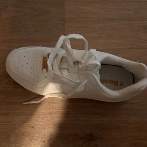 Vita sneakers från Bershka - Snygga vita sneakers från Bershka med en chunky sula och klassisk snörning. Perfekta för en stilren look. Tillverkade i syntetmaterial med en modern design.