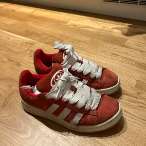 Röda sneakers från Adidas - Snygga röda sneakers från Adidas med vita detaljer och breda snören, har även dom röda snörena som skickad med. Använda men Sååå sköna. Pris kan diskuteras 