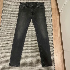 Svarta jeans från Diesel - Säljer ett par svarta jeans från Diesel. De är slim fit och har en skinny stil. Jeansen är i stretchmaterial vilket gör dem bekväma att ha på sig. Perfekta för både vardag och fest!