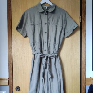 Jumpsuit - Superfin jumpsuit i naturgrön färg! Jättebra skick, bara i behov av en strykning. Storlek M.