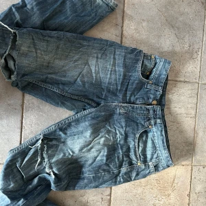 Low waist jeans med slitningar  - Säljer dom hög jätte snygga jeans som är löpors second hand dom har hål vid knäna och är lågmidjade och bootcut. Jag skulle säga att dom är 34/36 passar mig som har 36. Hör av er vi några funderingar🤗