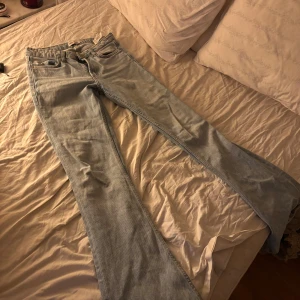 Ljus blå bootcut jeans lågmidjade - En par blå bootcut jeans som är lågmidjade. Använda men ändå bra skick. Säljer då som e för små i midjan. Storlek 34. Dom e lite slitna där nere men inte mycket så man ser knappt. Lite vid midjan. 