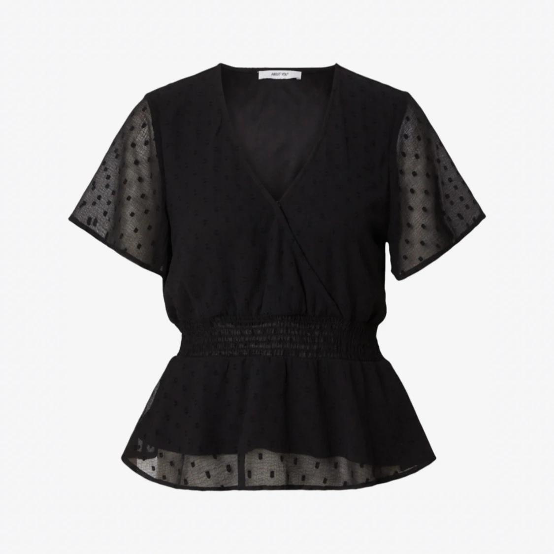 Svart blus med prickigt mönster
