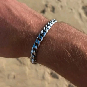 Rostfritt Stål Silverfärgat Armband - Snyggt silverfärgat armband med en klassisk kedjedesign. Perfekt för att ge en stilren touch till din outfit. Armbandet har en justerbar kedja för att passa olika storlekar.