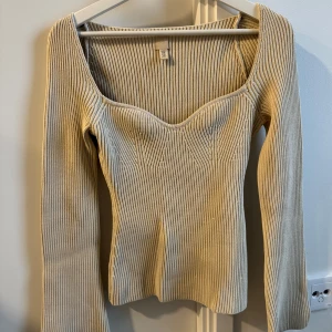 Beige ribbad tröja från H&M - Säljer en stickad beige tröja från H&M. Den har hjärtringning och långa ärmar som är utsvängda i slutet. Storlek XS men passar också S. I tjockt material. Superfin passform, endast använd en gång 🌟