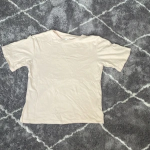 Beige t-shirt från lager 157 - Säljer en stilren beige t-shirt från lager 157 i storlek XS. T-shirten är tillverkad i 100% bomull och har en klassisk rund halsringning. Perfekt för en enkel och avslappnad stil.