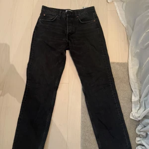 Svarta jeans från Zara - Säljer ett par svarta jeans från Zara i bra skick. De har en klassisk femficksdesign och knappar i gylfen. Perfekta för både vardag och fest!