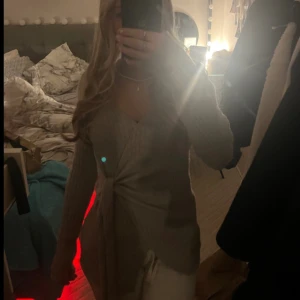 Grå ribbad omlottkofta - Säljer en superfin grå ribbad omlottkofta med knytning i midjan. Den har långa ärmar och en mysig passform, perfekt nu till hösten 