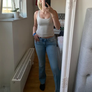Ljusblå bootcut jeans från Pepe Jeans - Säljer ett par ljusblå jeans från Pepe Jeans i klassisk bootcut-modell. Jeansen har en låg passform, fem fickor och är tillverkade i bomull med lite stretch. Perfekta till sneakers eller boots och ger en chill vibe till outfiten. Storlek: Midja:29 längd:32.