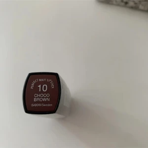 Isadora Perfect Matt Lipstick Choco Brown - Matt läppstift från Isadora i färgen 10 Choco Brown. Snygg brun nyans med chokladton, perfekt för dig som gillar en naturlig men ändå markerad look. Kommer i klassisk hylsa och ger en matt finish på läpparna.