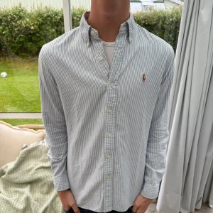 Blå randig Ralph lauren skjorta - Säljer en riktigt fet ralph lauren oxford skjorta i storlek S slim fit, Riktigt fet sommarfärg. grabben på bilden är 185 cm 70kg, hör gärna av er vid funderingar mvh AeCloset!💯