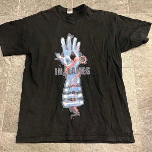 In Flames t-shirt  - Rätt liten i storlek. Står att den är medium, men känns mer som small.  Trycket är helt intakt, men har spruckit upp lite (se bild). I övrigt fint skick.