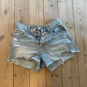 jeansshorts från zara med slitningar - snygga jeansshorts från zara med slitna detaljer för en cool vibe😍den har knappar framtill och ljus tvätt, perfekt för sommardagar och streetstyle🫶🏼
